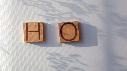 The word "HOT" is laid out in wooden letters