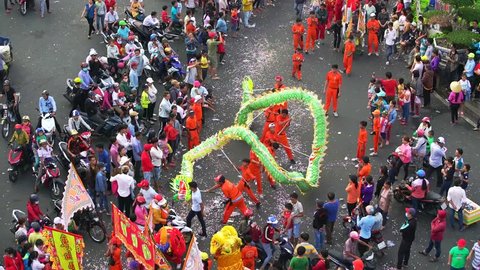 Binh Duong, Vietnam - March 2nd, 2018: Dragon dance festival on the street with martial arts dragon winding control Practitioners of the Chinese Lantern Festival in Binh Duong, Vietnam