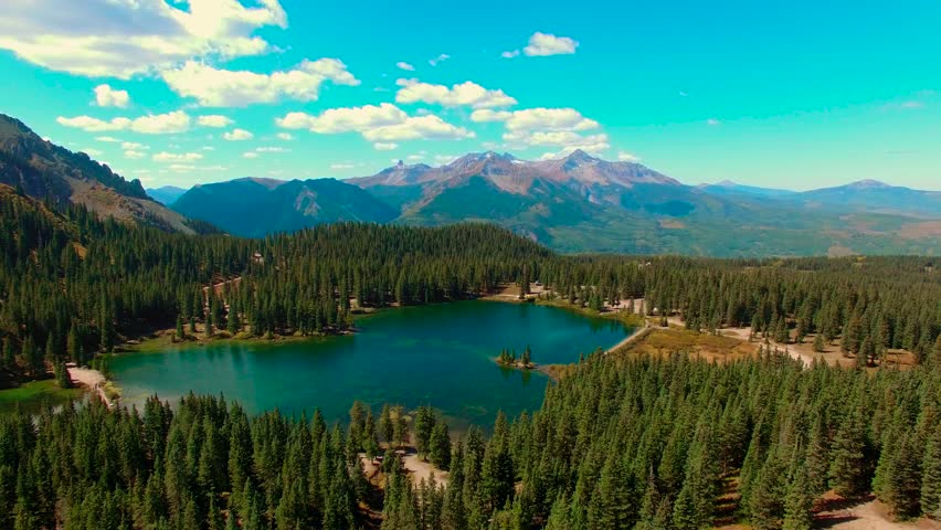 Aerial view of a sapphire blue alpine lake in the Rocky Mountains of Colorado