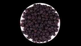 Plate with blackberry rotates on a black background

