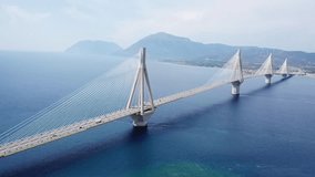Aerial bird's eye drone video of state of the art suspension bridge crossing the deep blue sea