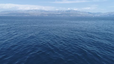 Flight over ocean, open sea. Dynamic aerial shot, after camera tilt - Mediterranean sea