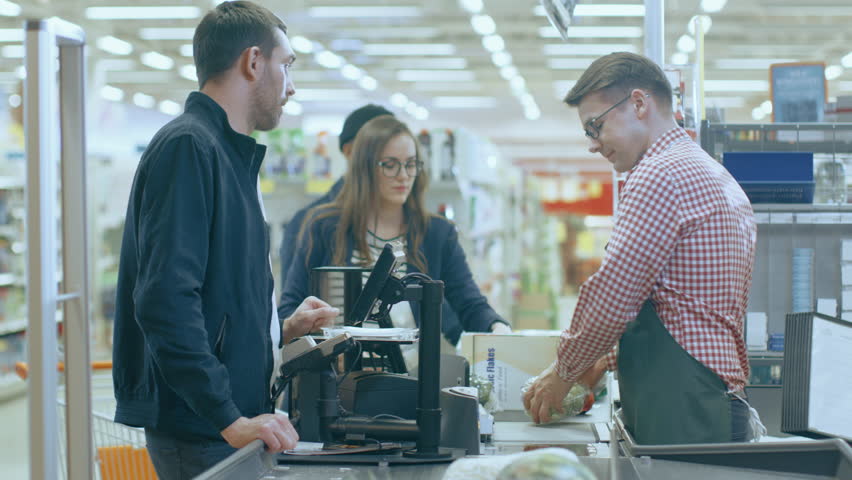 At the Supermarket: Checkout Counter Professional Cashier Scans Groceries and Food Items. Clean Modern Shopping Mall. Shot on RED EPIC-W 8K Helium Cinema Camera. Royalty-Free Stock Footage #1015777330