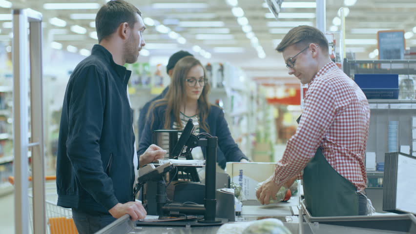At the Supermarket: Checkout Counter Professional Cashier Scans Groceries and Food Items. Clean Modern Shopping Mall. Shot on RED EPIC-W 8K Helium Cinema Camera. | Shutterstock HD Video #1015777330