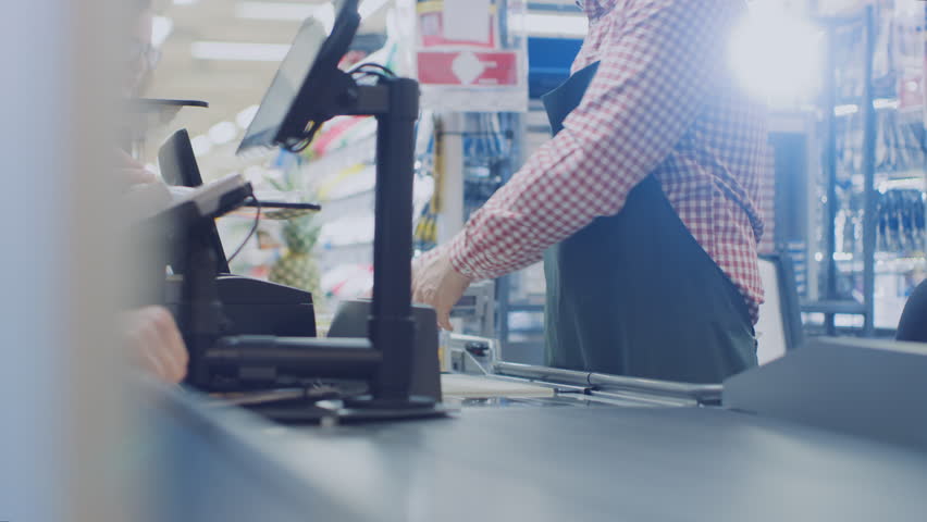At the Supermarket: Checkout Counter Hands of the Cashier Scans Groceries and Food Items. Clean Modern Shopping Mall with Efficient Queue Management. Shot on RED EPIC-W 8K Helium Cinema Camera. Royalty-Free Stock Footage #1015777339