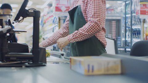 At the Supermarket: Checkout Counter Hands of the Cashier Scans Groceries and Food Items. Clean Modern Shopping Mall with Efficient Queue Management. Shot on RED EPIC-W 8K Helium Cinema Camera.