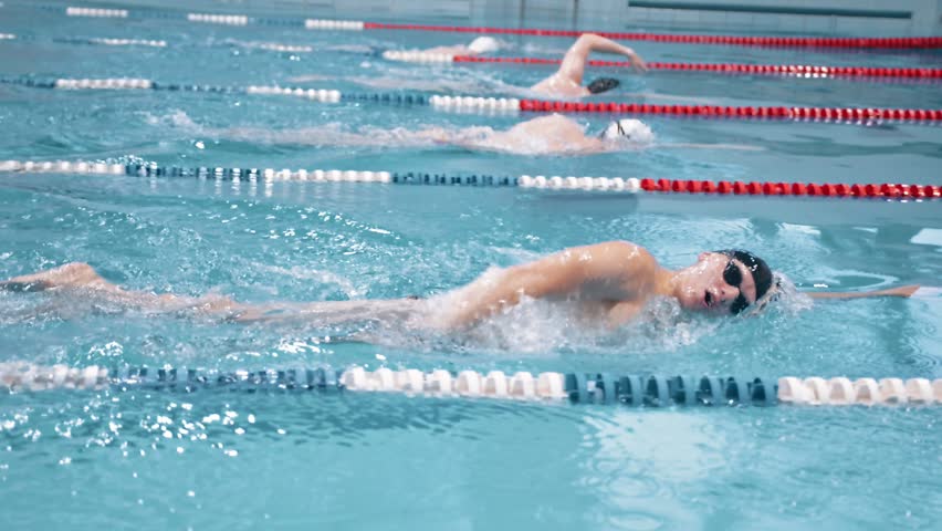 Slow motion swimmer competition or training at swimming pool