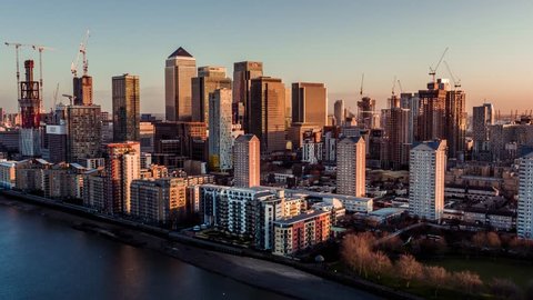 Establishing Aerial View shot of Canary Wharf in London Financial District United Kingdom superb skyscrapers flooded with beautiful light  