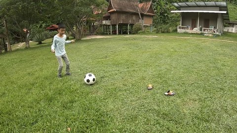 active kids having fun and kicking football in park on summer day together