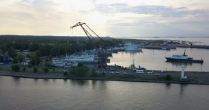 4K aerial early evening video of Lomonosov (Oranienbaum) harbour and port shipyard service area, Finnish Bay panorama, boats moored at Baltic Sea coast, in surroundings of Russia's northern capital