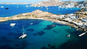 Aerial drone bird's eye view video from famous beach of Paraga featuring iconic club of Skorpios and Santanna with largest pool in Europe, Mykonos island, Cyclades, Greece