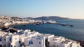 Aerial drone, bird's eye view video of iconic whitewashed Cycladic houses in old port of Mykonos island next to little Venice, Cyclades, Greece