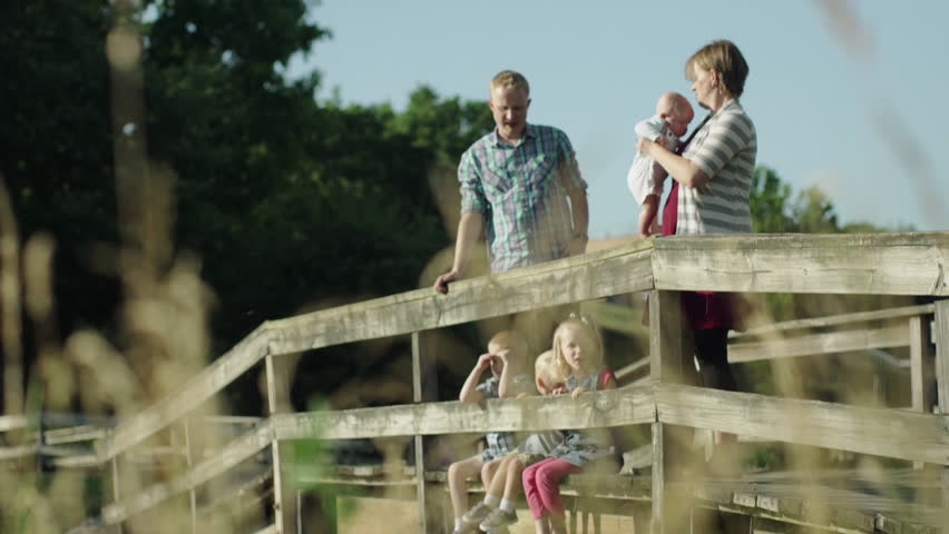 Happy family with four children on bridge in park full HD