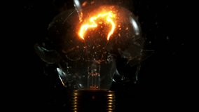Super slow motion of light bulb explosion isolated on black background. Filmed on super slow motion cinema camera, 2000 fps. - Powered by Shutterstock - Get 15% off with code: PIKWIZARD15
