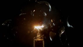 Super slow motion of light bulb explosion isolated on black background. Filmed on super slow motion cinema camera, 2000 fps. - Powered by Shutterstock - Get 15% off with code: PIKWIZARD15