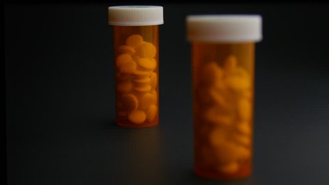 Pill Bottle Full of Opioids on Table Rack Focus
