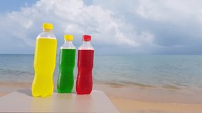 Video colored bottles on the beach near the sea