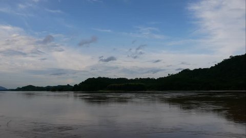 4k, time lapse, Clouds flow through mountains on the Mekong River in Laos.