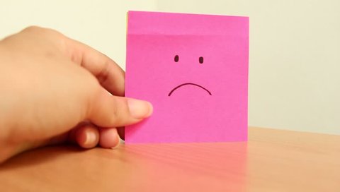 Change paper sticky note unhappy to happy face.