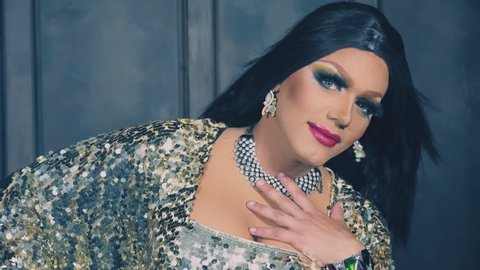 travesty-diva. The concept of the transvestite show. Man-actor turns into a woman. he dances, sings and poses on camera. 4k, slow motion, shooting steadicam