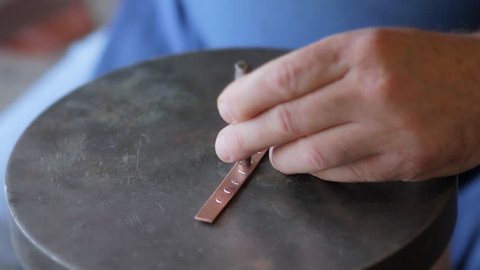Crimean Tatar master makes a copper bracelet