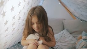 Video montage  of funny cute little girl playing in bed. Different emotions, artistic child.