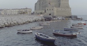 Aerial Drone footage view of Castel Dell’OVO in Naples Italy seaport sea evening  // no video editing