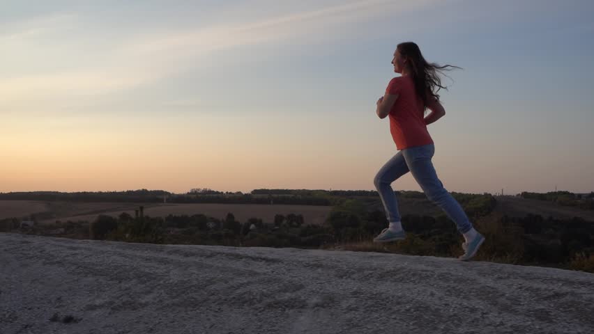 Girl Runs up the Mountain, morning  Exercising for health, slow motion, steadicam | Shutterstock HD Video #1015848313