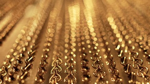 Gold background for relaxation. Uniform swing. Slow smooth movement of long gold chains. Meditation. Relax. Texture for soothing. Glitter. View from bottom to top. Blurred Adlı Stok Video