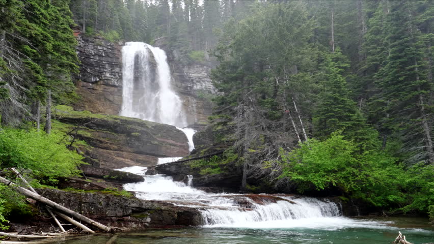 misty day at virginia falls in glacier national park in montana, usa