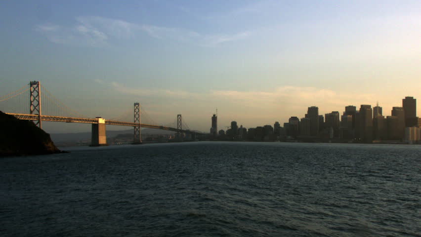 Timelapse day to night of bay with Golden Gate Bridge and crescent moon San Francisco California