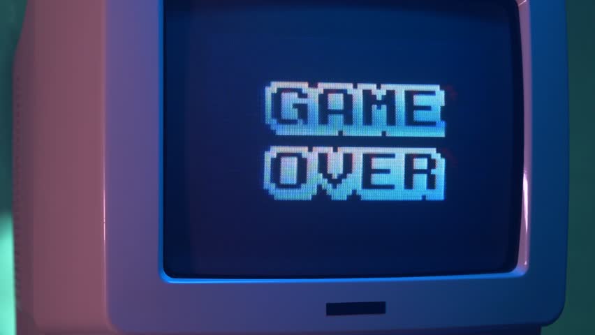 GAME OVER title on a tube TV Vintage 80's 90's arcade.Zooming out with fog giving a retro look at the scene. Royalty-Free Stock Footage #1015901956