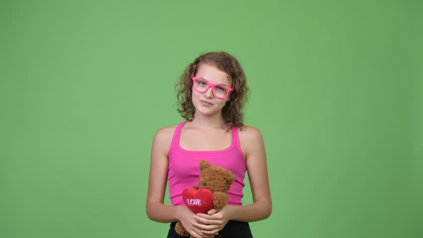 Young beautiful nerd woman giving teddy bear