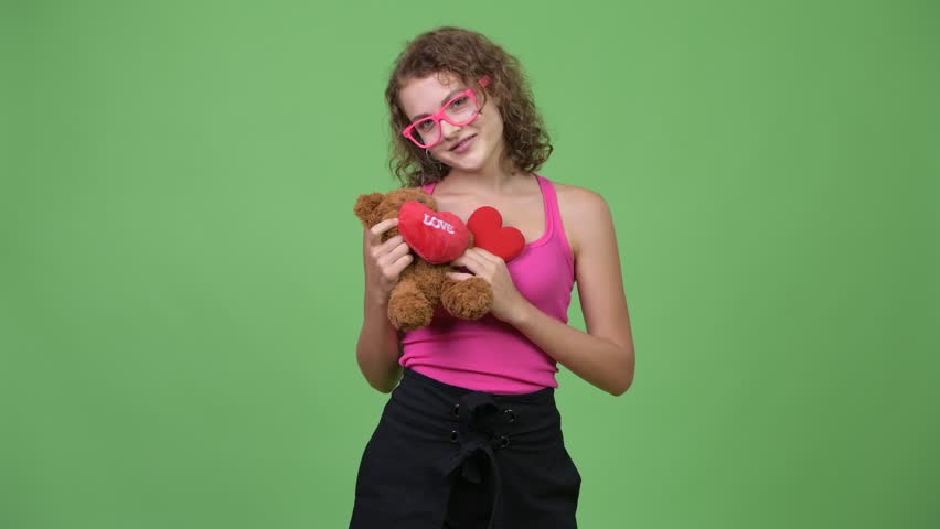 Young happy beautiful nerd woman hugging teddy bear