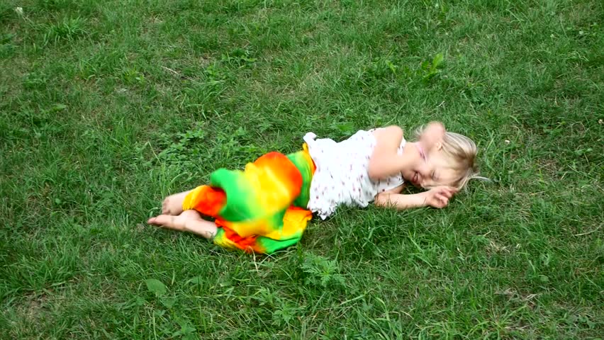 The girl lying on the grass. Emotions smile