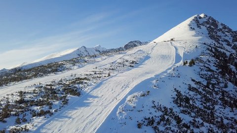 Aerial view of skiers on ski slope on Strbske Pleso resort in High Tatras mountains, Slovakia.