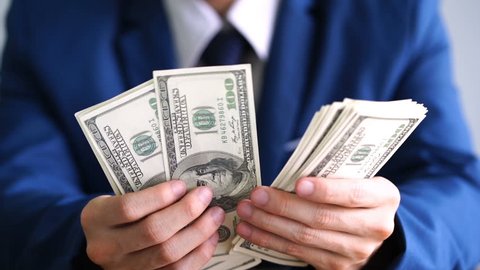 Man financial adviser and holding money banknotes, businessman wear blue suit management counting dollar bills cash.