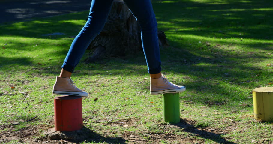 Woman playing in the park on a sunny day 4k
