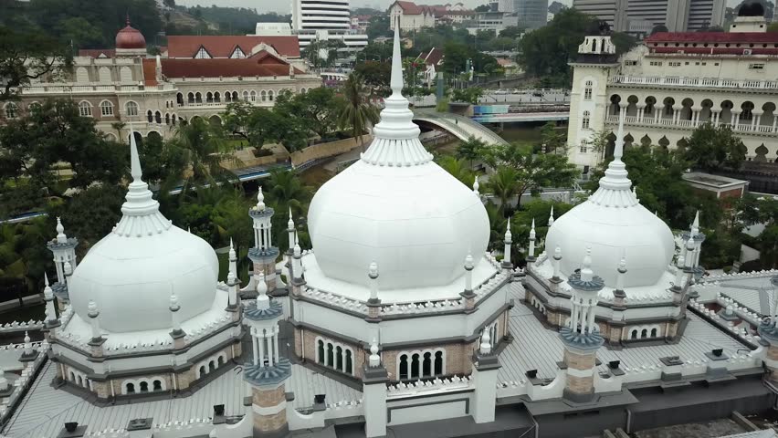 Aerial drone Sultan Abdul Samad building mosque Kuala Lumpur central square. Capital of Malaysia asia. Clock tower arc decoration modern skyscrapers skyline
