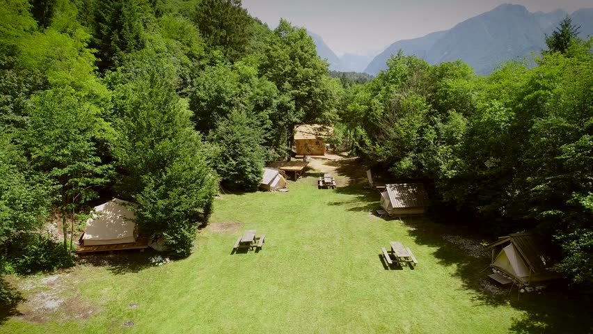 Aerial view of a summer camp with cabins and recreational area in the forest at Slovenia.