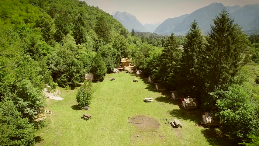 Aerial view of a summer camp with cabins and recreational area in the forest at Slovenia.