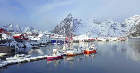 Aerial panorama drone view of beautiful Lofoten Islands winter scenery with traditional fishing boats lying in harbor of famous Hamnoy village on a cold sunny day, Norway, Scandinavia, northern Europe