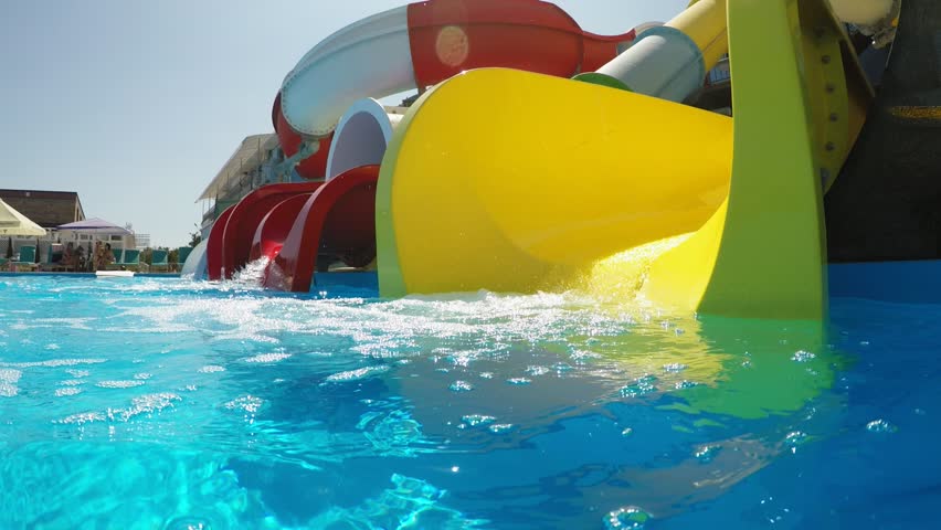 Colorful clear water slides in the aqua park, slow motion  | Shutterstock HD Video #1015940062