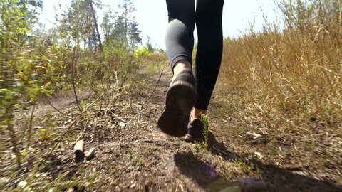 Elastic buttocks, athletic ass, The girl is walking on a forest trail