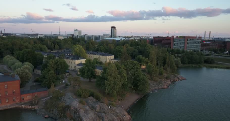 4K summer sunset aerial video of Helsinki Lapinlahti historical mental hospital completed in 1841, not in operation from 2008, woods area around it, in the capital of Finland Suomi, northern Europe