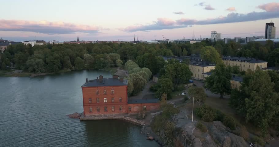 4K summer sunset aerial video of Helsinki Lapinlahti historical mental hospital completed in 1841, not in operation from 2008, woods area around it, in the capital of Finland Suomi, northern Europe