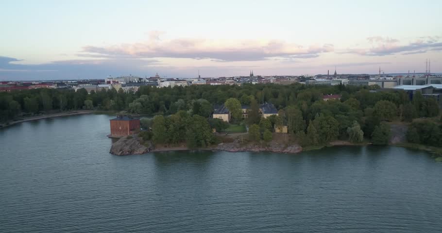 4K summer sunset aerial video of Helsinki Lapinlahti historical mental hospital completed in 1841, not in operation from 2008, woods area around it, in the capital of Finland Suomi, northern Europe