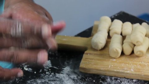 Preparing Latin American fast food called Tequenos made of fried corn filled with cheese.