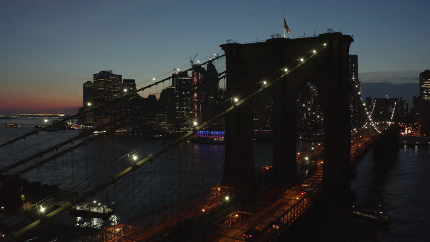 night flying along Brooklyn Bridge towards downtown Manhattan view Royalty-Free Stock Footage #1015951396