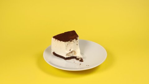 Eating a piece of cake on a white dish - Stop motion
